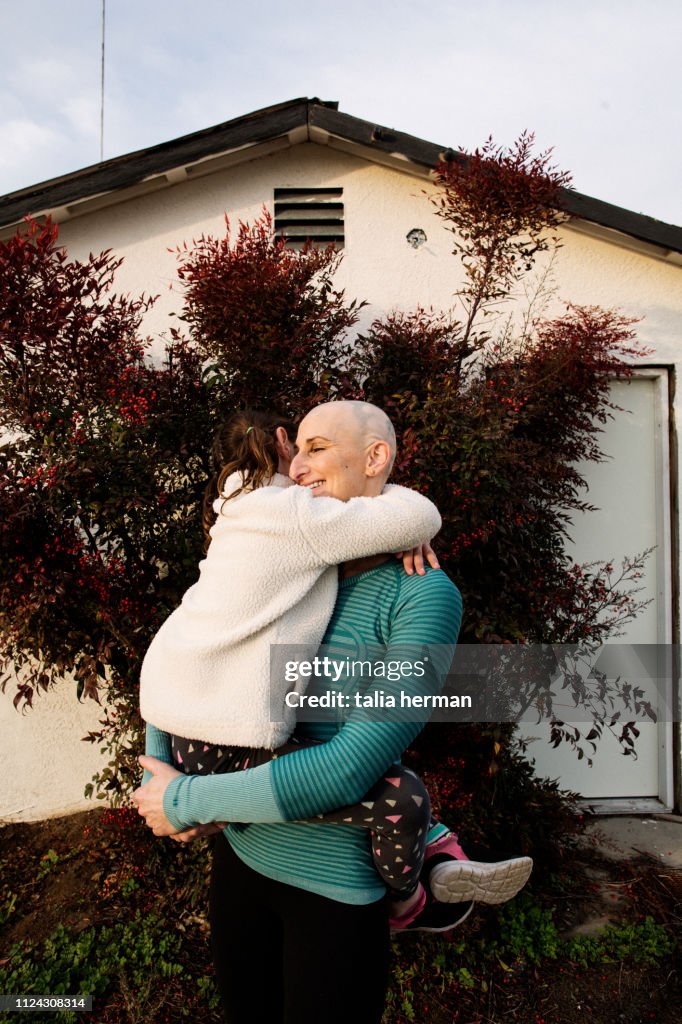 A portrait of a bald woman with her daughter