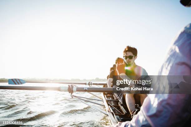 rowing team in scull on the river - aviron photos et images de collection