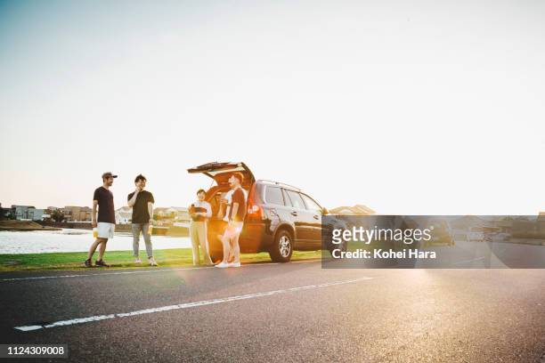 group of friends talking and getting relaxed by car outdoors - land vehicle stock pictures, royalty-free photos & images