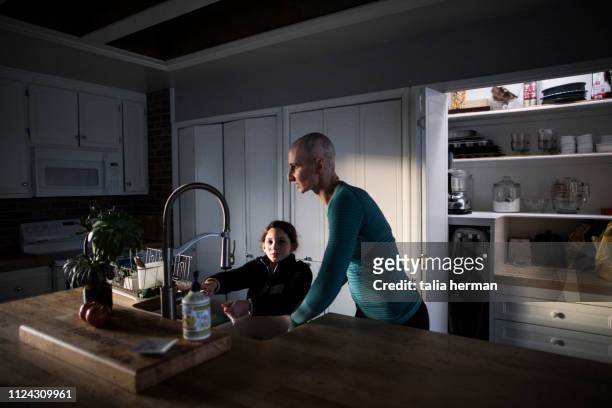 mother and daughter at kitchen sink