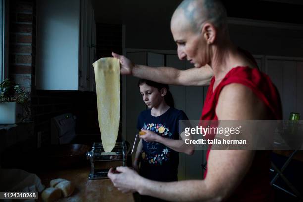 mother with alopecia making pasta with her daughter - stanislaus county stock pictures, royalty-free photos & images