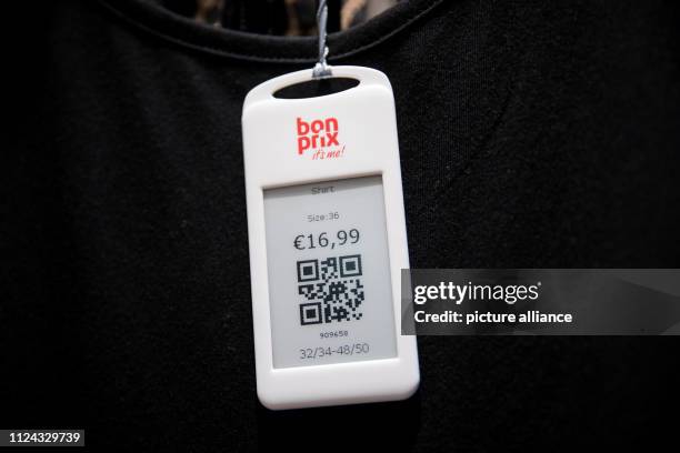 February 2019, Hamburg: A price tag with QR code hangs on a black T-shirt in the new Bonprix Pilot store in downtown Hamburg. Under the motto...