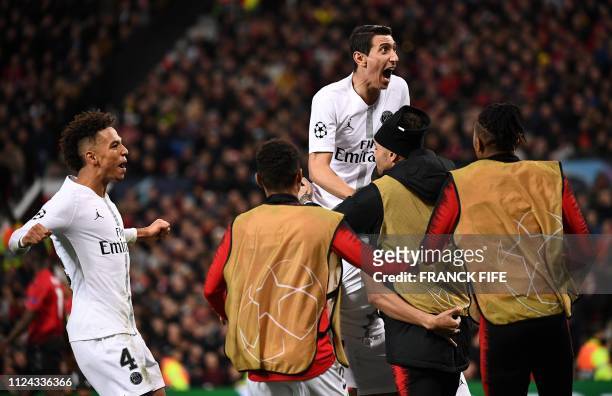 Paris Saint-Germain's Argentinian midfielder Angel Di Maria reacts as Paris Saint-Germain's French striker Kylian Mbappe is mobbed after scoring his...