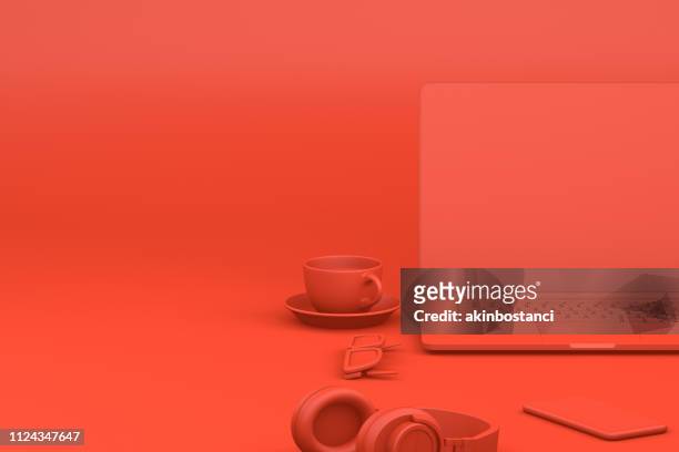 office desktop with laptop, red background, technology concept. - red headphones stock pictures, royalty-free photos & images