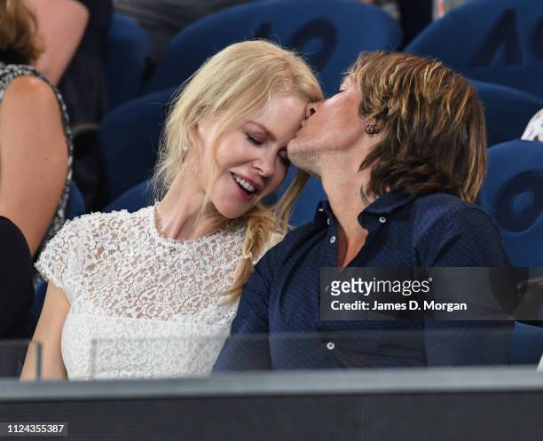 Nicole Kidman and Keith Urban share an affectionate moment during one of the women's semi finals on Rod Laver Arena as they attend the 2019...