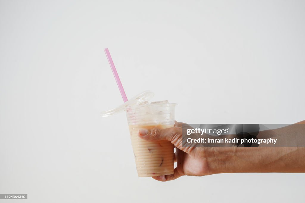 The pulled tea or Teh tarik in disposable Plastic PP Cup
