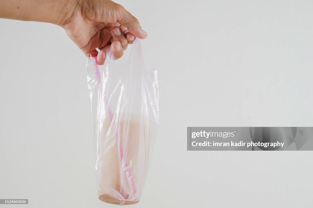 The pulled tea or Teh tarik in disposable Plastic PP Cup
