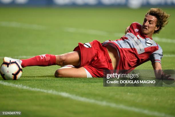 Leandro Onetto of Uruguay's Danubio slides to keep the ball, during their 2019 Copa Libertadores football match against Brazil's Atletico Mineiro...