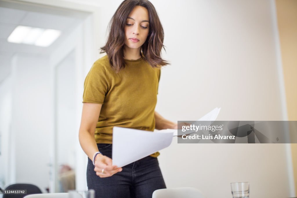 Female professional analyzing few documents