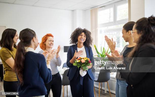 businesswomen celebrating an achievement of a colleague - gratitude foto e immagini stock