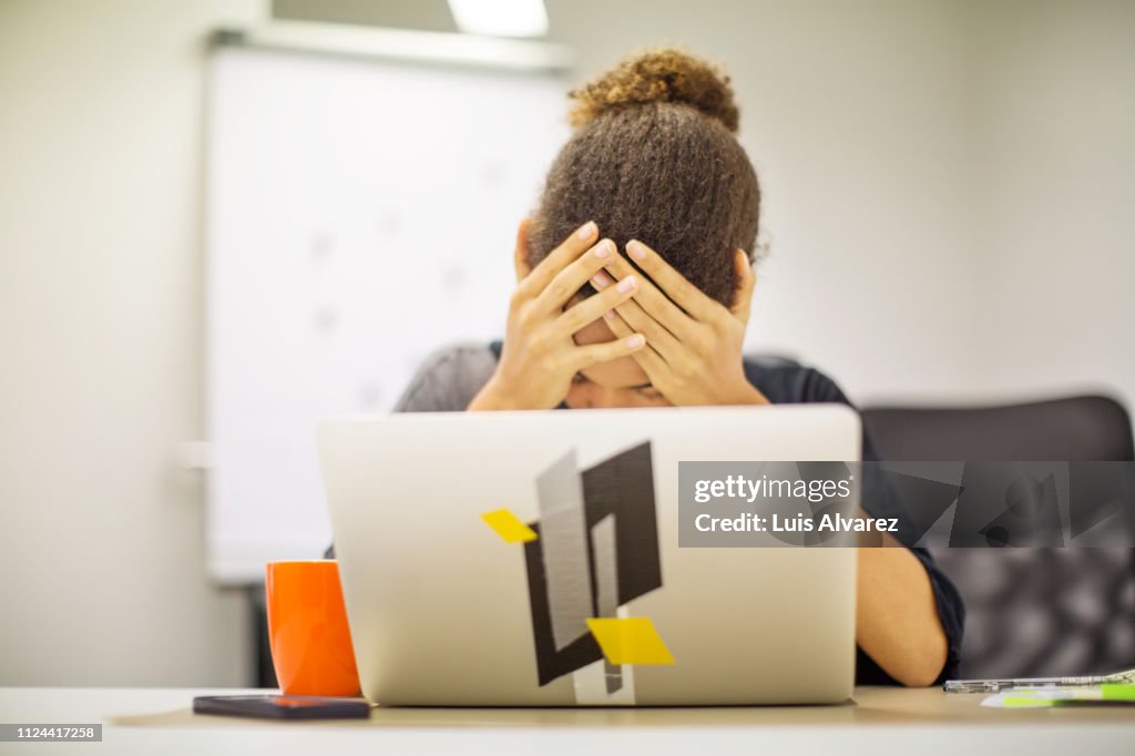 Businesswoman frustrated by bad new at office desk