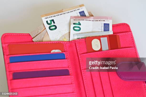 woman wallet with euro notes and credit cards - pink purse stock-fotos und bilder