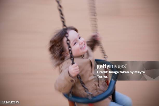 Todler having a great time in the swing