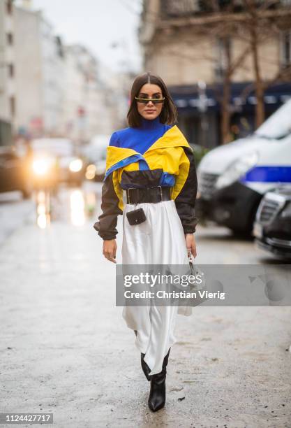 Camila Coelho is seen wearing multri colored jacket, belt with bag, high waist skirt outside Maison Margiela during Paris Fashion Week - Haute...