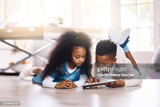 the digital world answers to their curiosity - sibling stock pictures, royalty-free photos & images