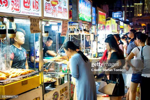 nanning zhongshan snack street with many people buying food - nanning stock pictures, royalty-free photos & images