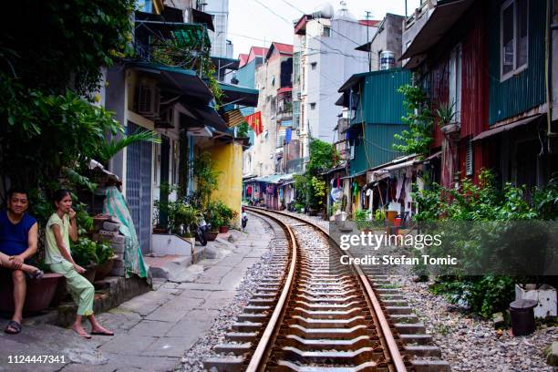 hanoi trein straat met spoorweg en bewoners zitten - hanoi stockfoto's en -beelden