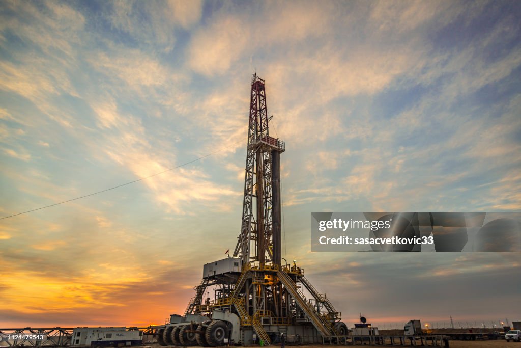 Oil drilling rig at dawn