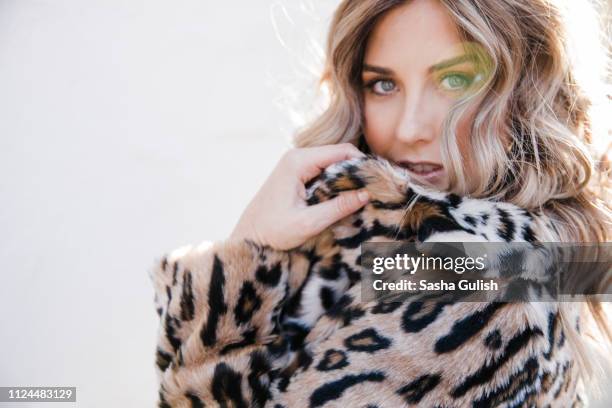 fashionable woman in leopard print coat - leopard print stock pictures, royalty-free photos & images
