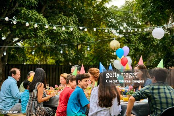 multi-generation family celebrating birthday party - kids birthday stock pictures, royalty-free photos & images