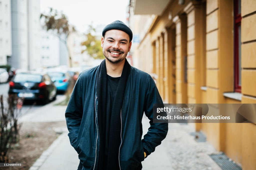 Portrait Of Young Man Smiling In City Street