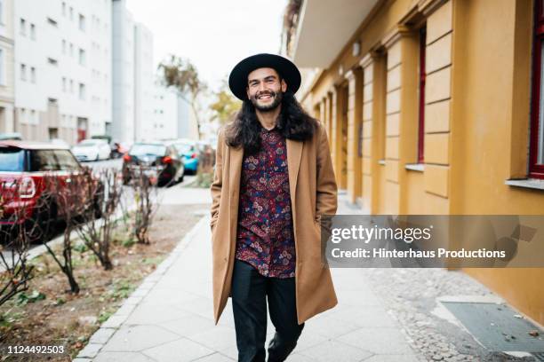 stylish young man on his way to meet friends - beige jacka bildbanksfoton och bilder