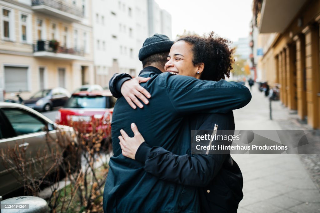 Friends Hugging In The Street