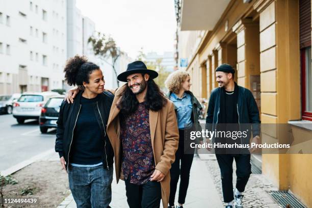 group of friends on their way to bar - millenials stock-fotos und bilder