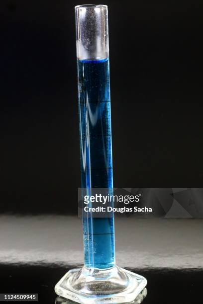 scientific graduated cylinder on a black background - measuring cylinder stock pictures, royalty-free photos & images