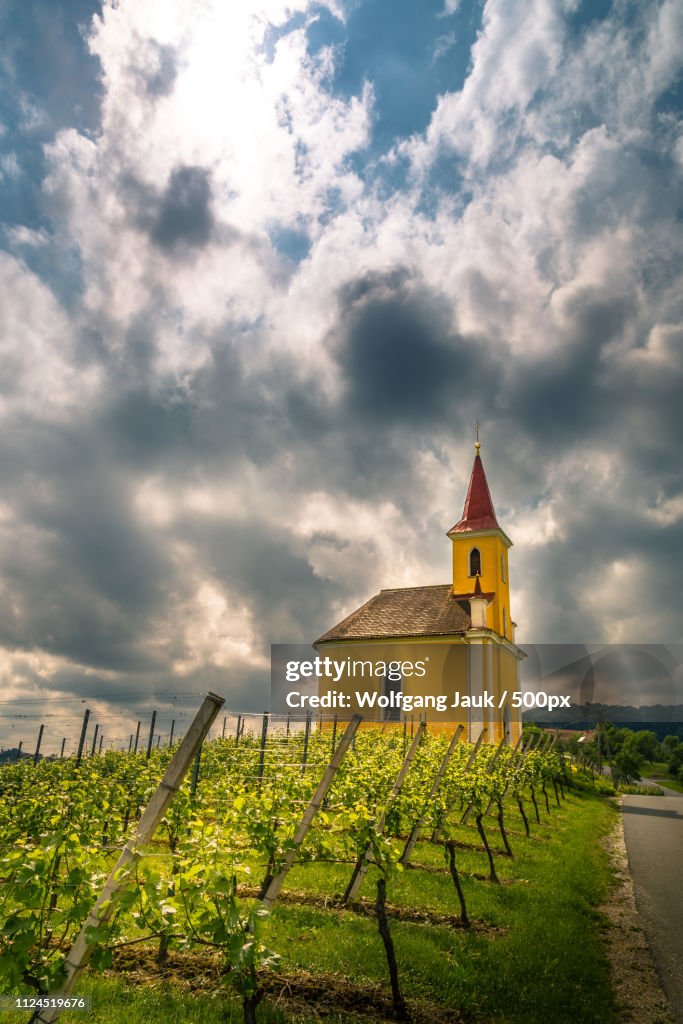 Clouds over vineyard in front of chapel