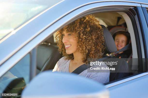 woman in car with little boy - car driving stock pictures, royalty-free photos & images