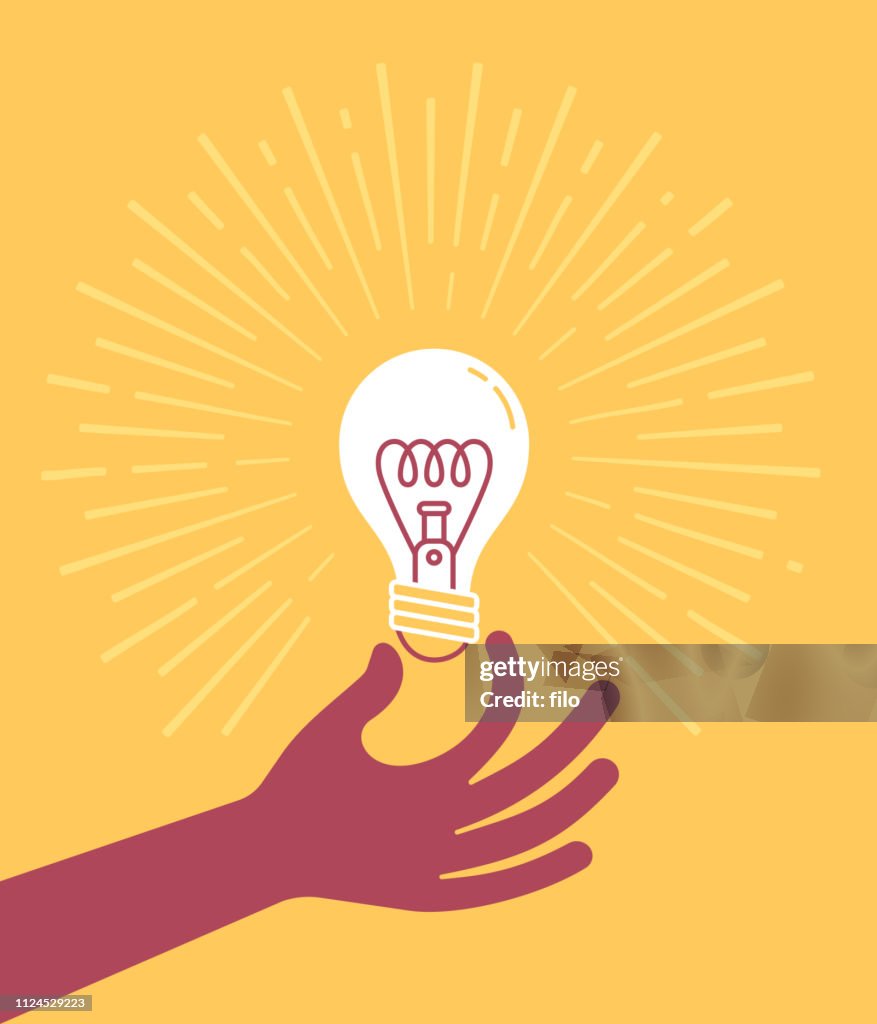 Hand som håller glödlampan