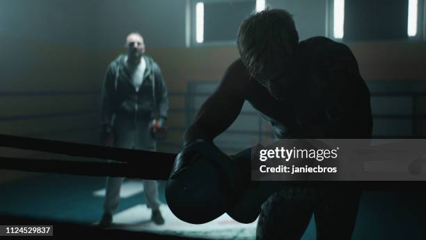 coach and exhausted boxer - boxing ring corner stock pictures, royalty-free photos & images
