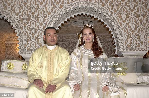 King Mohamed VI of Morocco sits with his wife Princess Lalla Salma at the royal palace July 13, 2002 in Rabat, Morocco. Public celebrations for the...