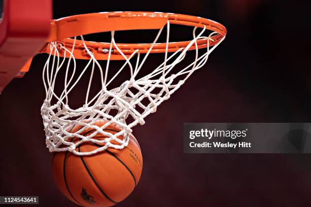 Basketball going through the hoop and net during warm ups before a game between the Arkansas Razorbacks and the Missouri Tigers at Bud Walton Arena...