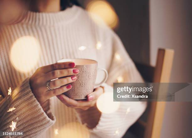 woman drinking coffee on a cold winter day - women pastel stock pictures, royalty-free photos & images