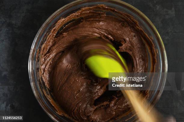mixing chocolate cake brownies batter in bowl - chocolate biscuit cake stock pictures, royalty-free photos & images