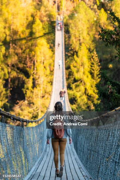 woman walking through goms bridge - famous swiss people stock pictures, royalty-free photos & images