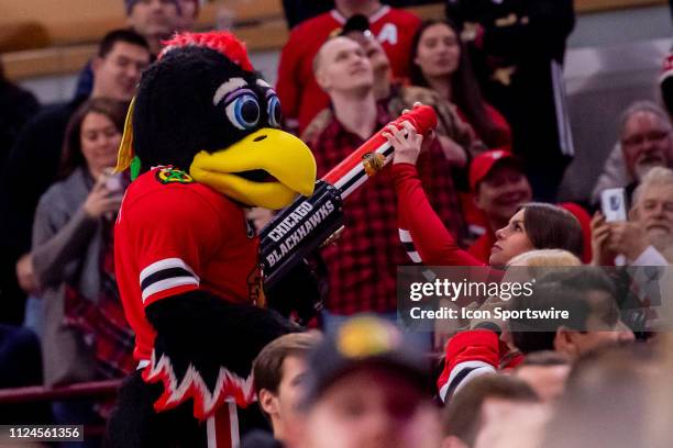 Member of the Ice Crew loads Chicago Blackhawks Tommy's t-shirt cannon during a game between the Detroit Red Wings and the Chicago Blackhawks on...