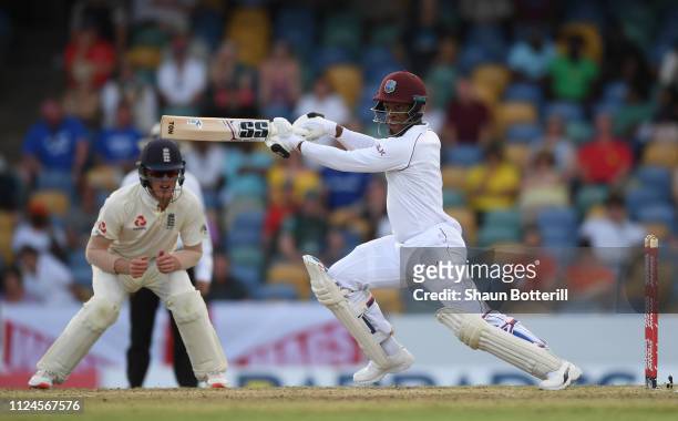 Shimron Hetmyer of West Indies plays a shot as Keaton Jennings of England looks on during Day Two of the First Test match between England and West...