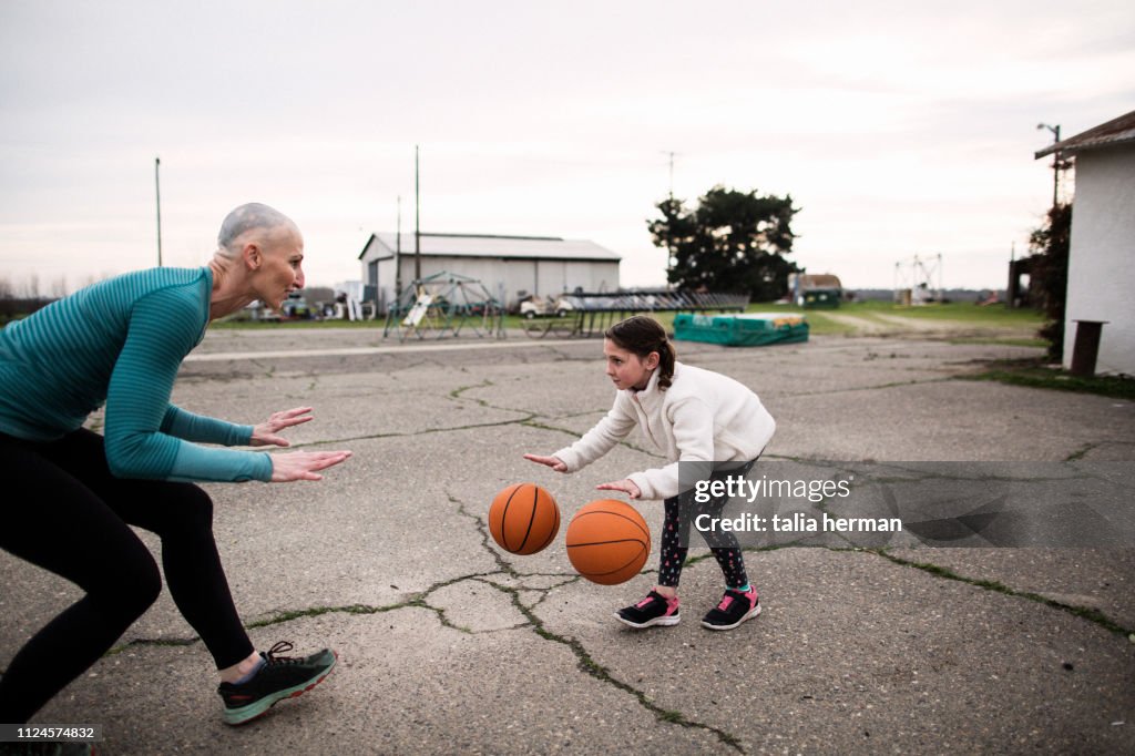 Bald mother and basketball coach trains twin daughters