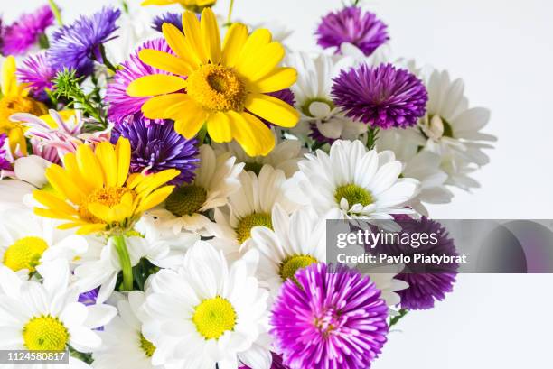 A fragment of a bouquet of beautiful bright flowers with the effect of a 'glossy magazine' on a light background. Light, bright and colorful spring photography