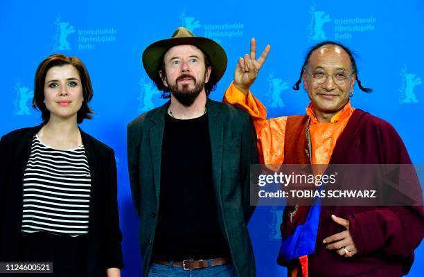 German journalist and protagonist Eva-Maria Lemke, German director Uli M Schueppel and protagonist Lama Gelek Ngawang pose during a photocall for the...