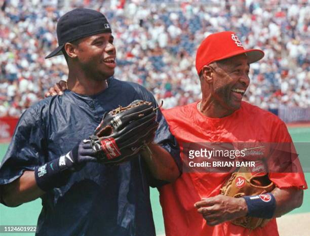 St. Louis Cardinals' shortstop Ozzie Smith , playing in his 15th and final All-Star Game, meets with Seattle Mariners' Ken Griffey Jr. During...
