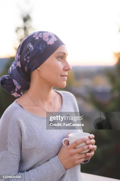 woman battling cancer standing outside and thinking about life - patience stock pictures, royalty-free photos & images