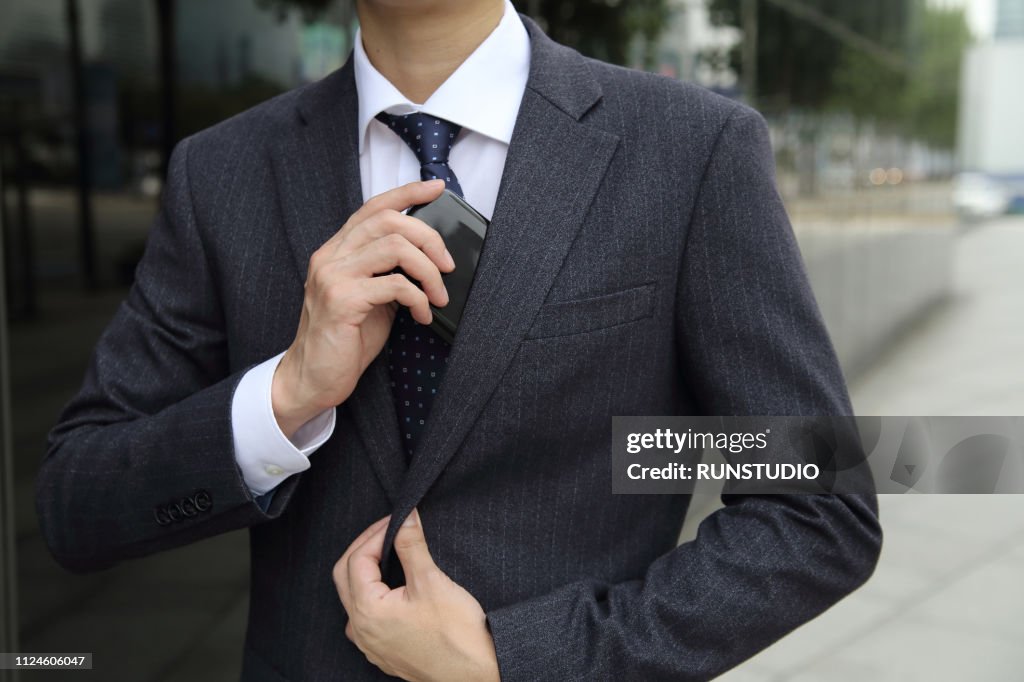 Close up of businessman take out wallet from suit jacket