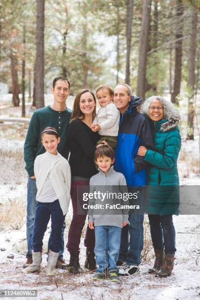 multigenerational family portrait in the woods - multi generation family winter stock pictures, royalty-free photos & images