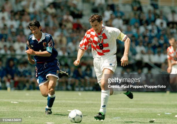 Davor Suker of Croatia is chased down by Masami Ihara of Japan during the 1998 FIFA World Cup Group H match at the Stade de la Beaujoire on June 20,...
