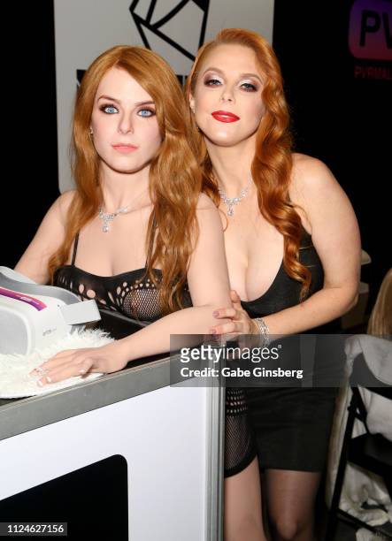 Adult film actress Penny Pax poses next to a sex doll modeled after her in the PVR and MissDoll booth at the 2019 AVN Adult Entertainment Expo at the...