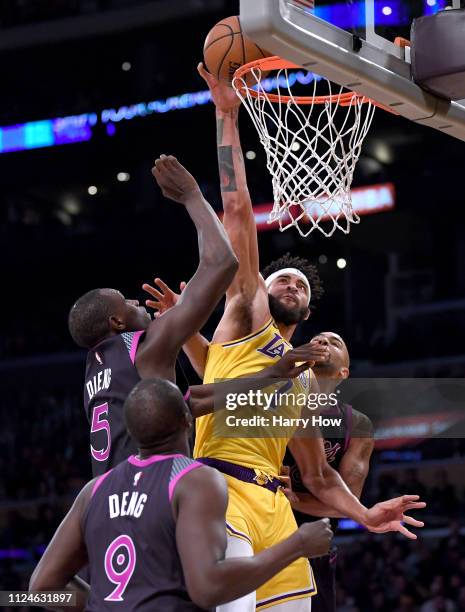 JaVale McGee of the Los Angeles Lakers scores between Luol Deng, Gorgui Dieng and Jerryd Bayless of the Minnesota Timberwolves during a 120-105...